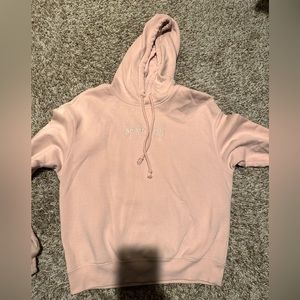 H&M pink hoodie with NO BAD VIBES written in the front